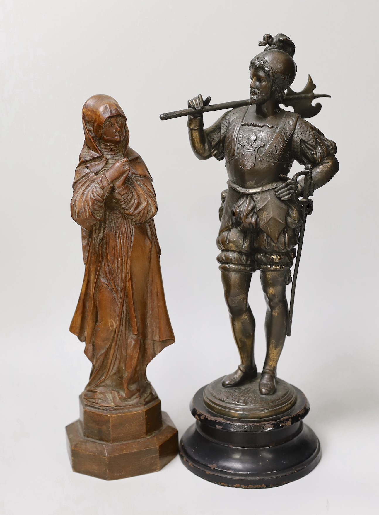 A 19th century carved wood figure of the ‘Virgin of Nuremberg’ together with a spelter figure of a guard. Tallest 38cm